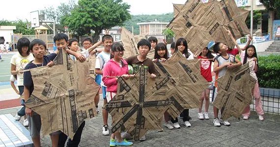 Students show off their construction skills by making kites out of newspapers during classes supported by the science education program.
