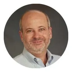 Portrait of a member with a beard wearing a light-colored shirt.